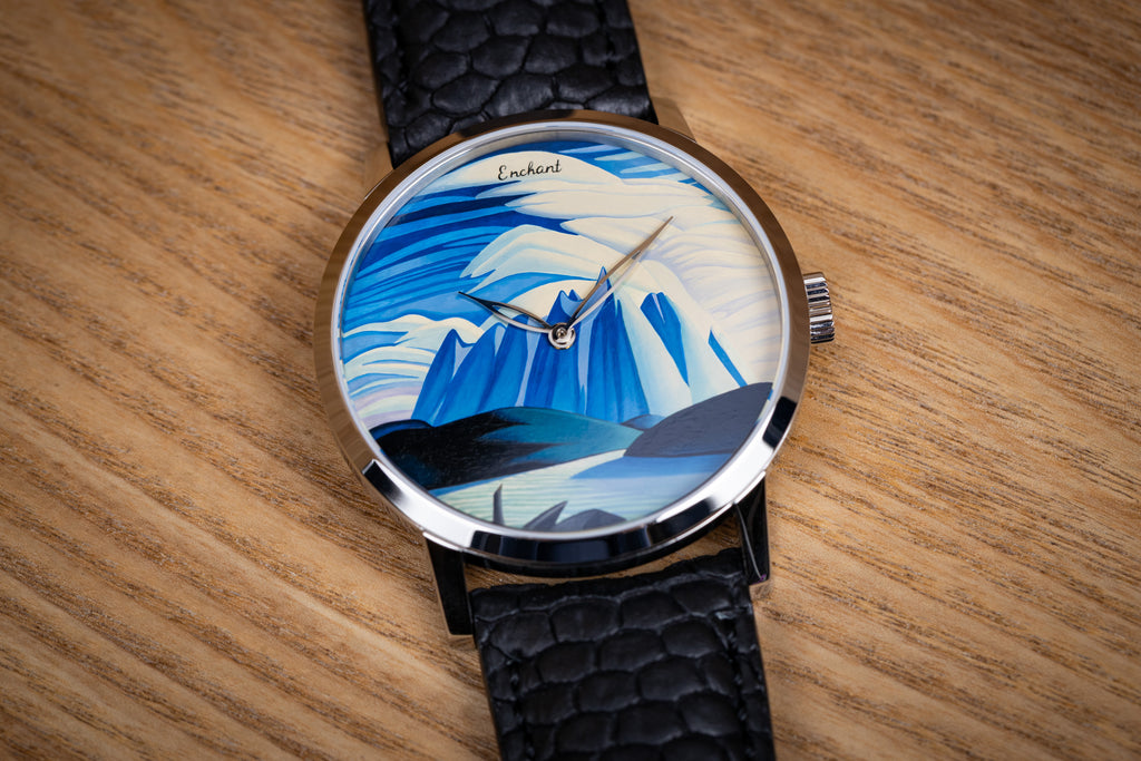 Lake and Mountains watch with a mountain design face on a wooden surface
