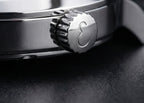 Close-up of a watch crown on a dark background